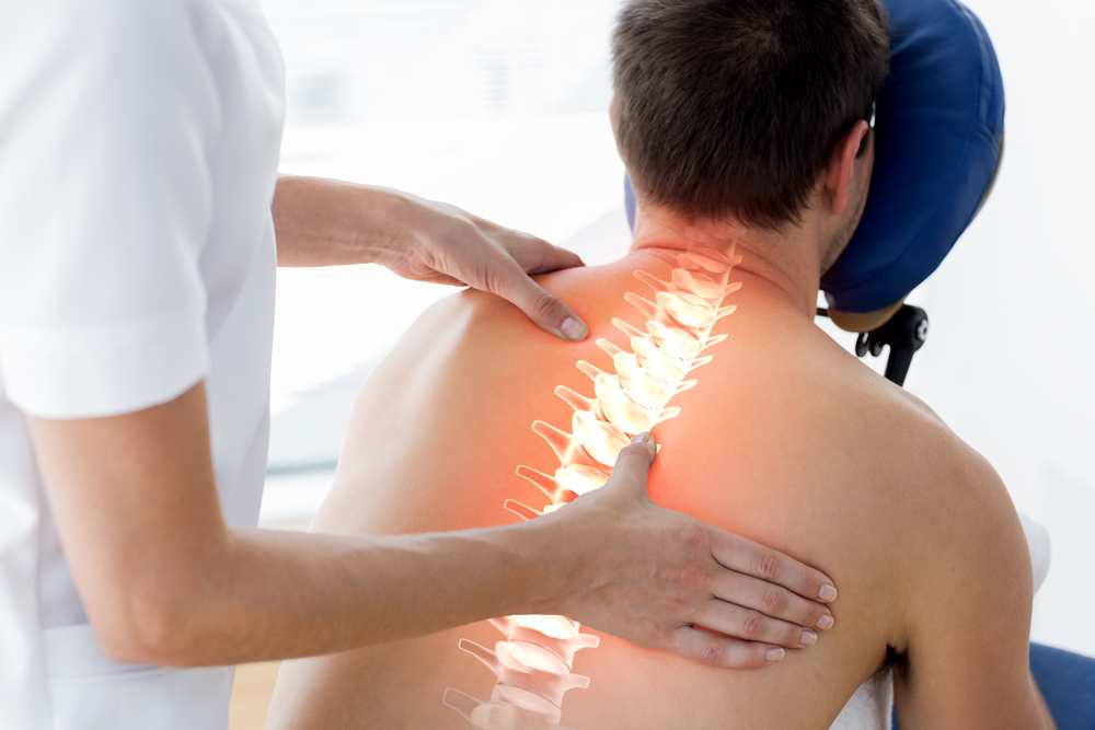 Doctor showing where to perform radiofrequency lesioning on spinal cord