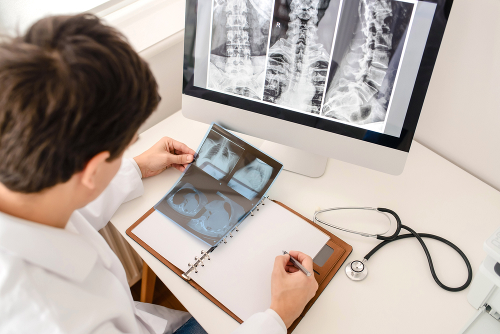 facet joint injection doctor looking at xray