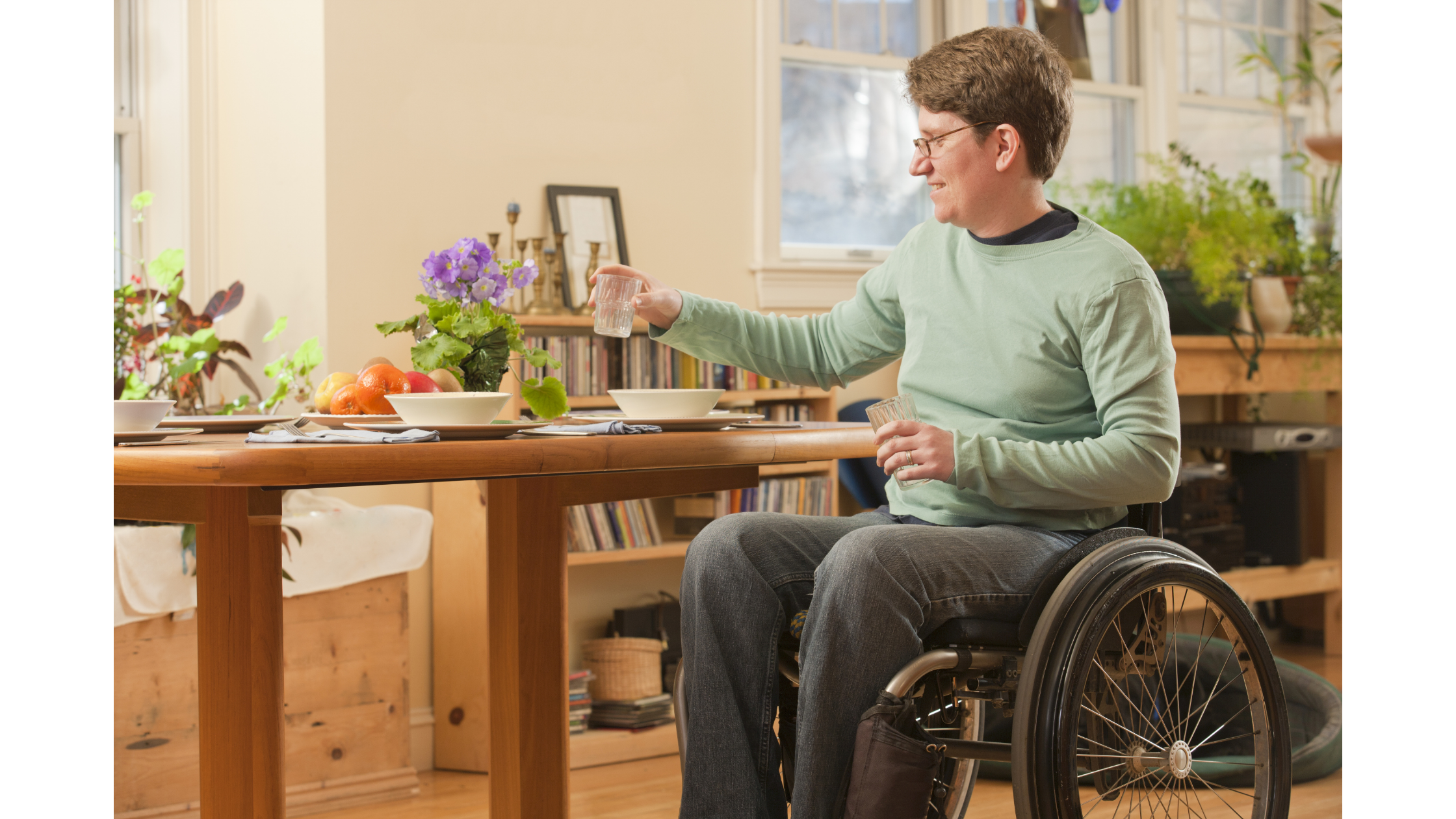 woman with multiple sclerosis in wheelchair at counter